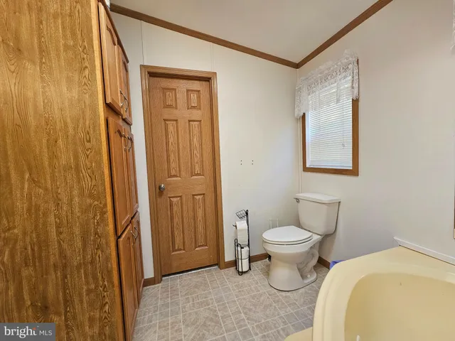 a bathroom with a toilet sink and a mirror