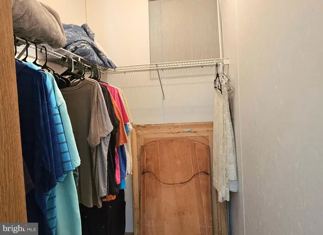 a bedroom with a bed and a flat tv screen