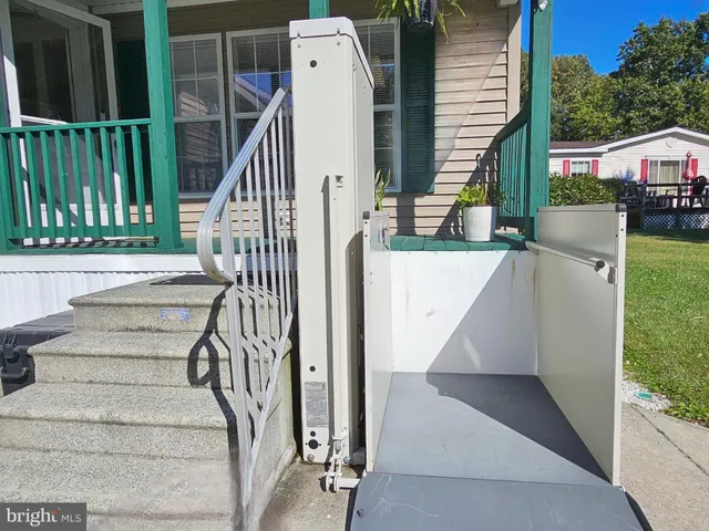 a view of a house with wooden deck and a backyard