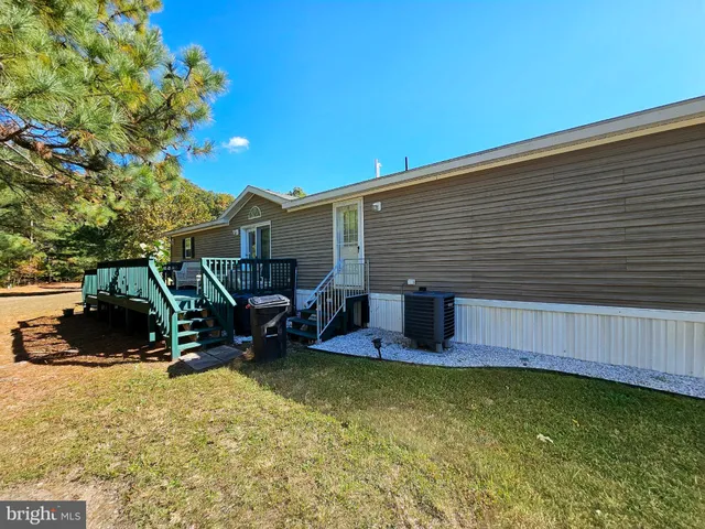 a view of a yard with large trees