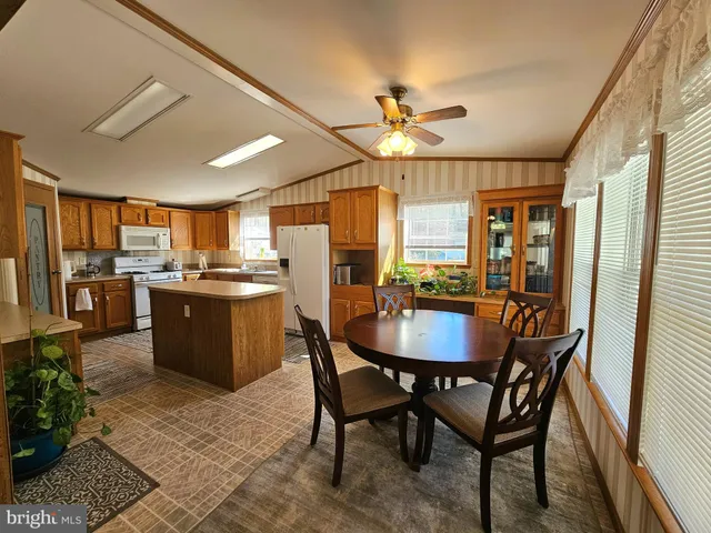 a view of a dining room with furniture and a kitchen