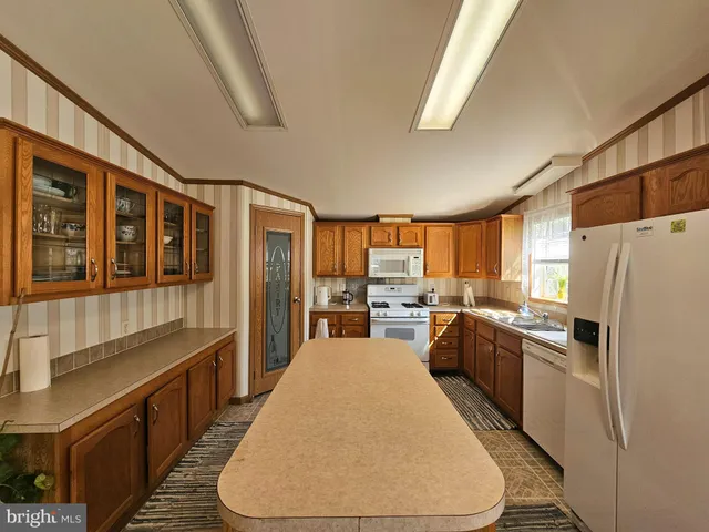a kitchen with stainless steel appliances a refrigerator sink and cabinets