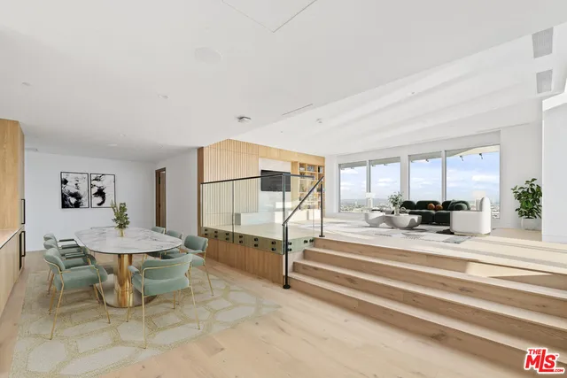 a large white kitchen with lots of counter space and glass door