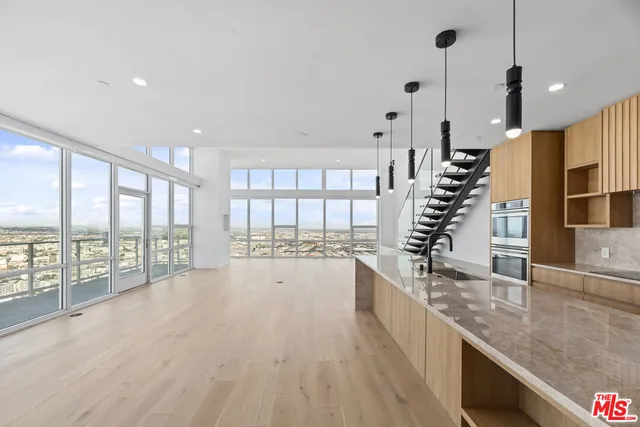 a bathroom with a granite countertop sink a toilet and shower