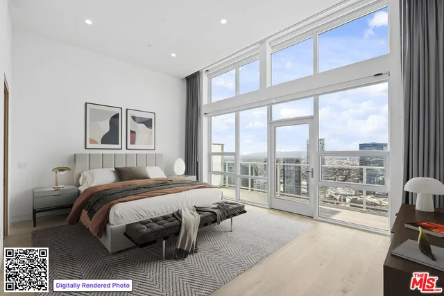 a bedroom with a bed couch and a large window