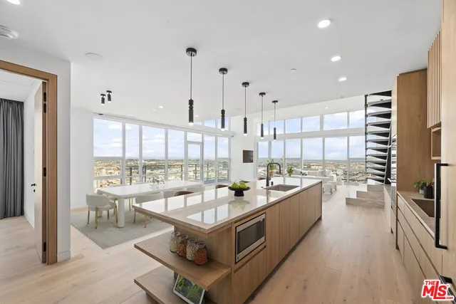 a large kitchen with lots of counter space and windows