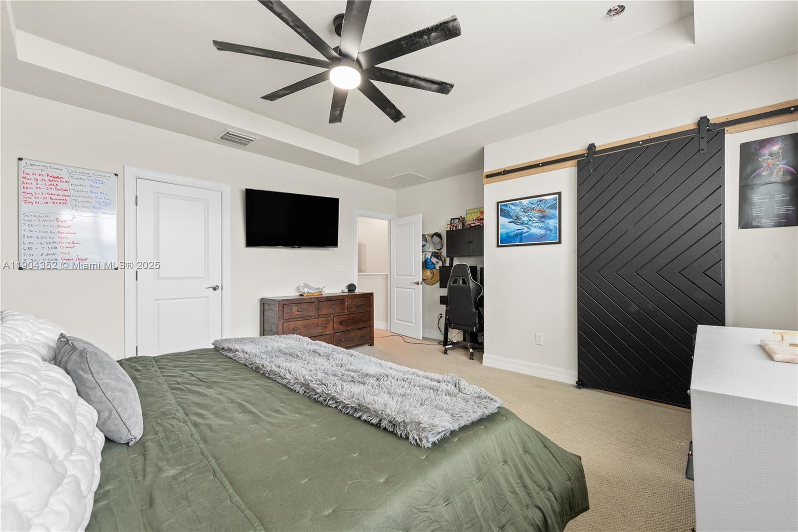 1030 Eucalyptus Drive, Unit 2 Hollywood, FL 33021 - Photo 12 of 22 a bedroom with a bed and a flat screen tv