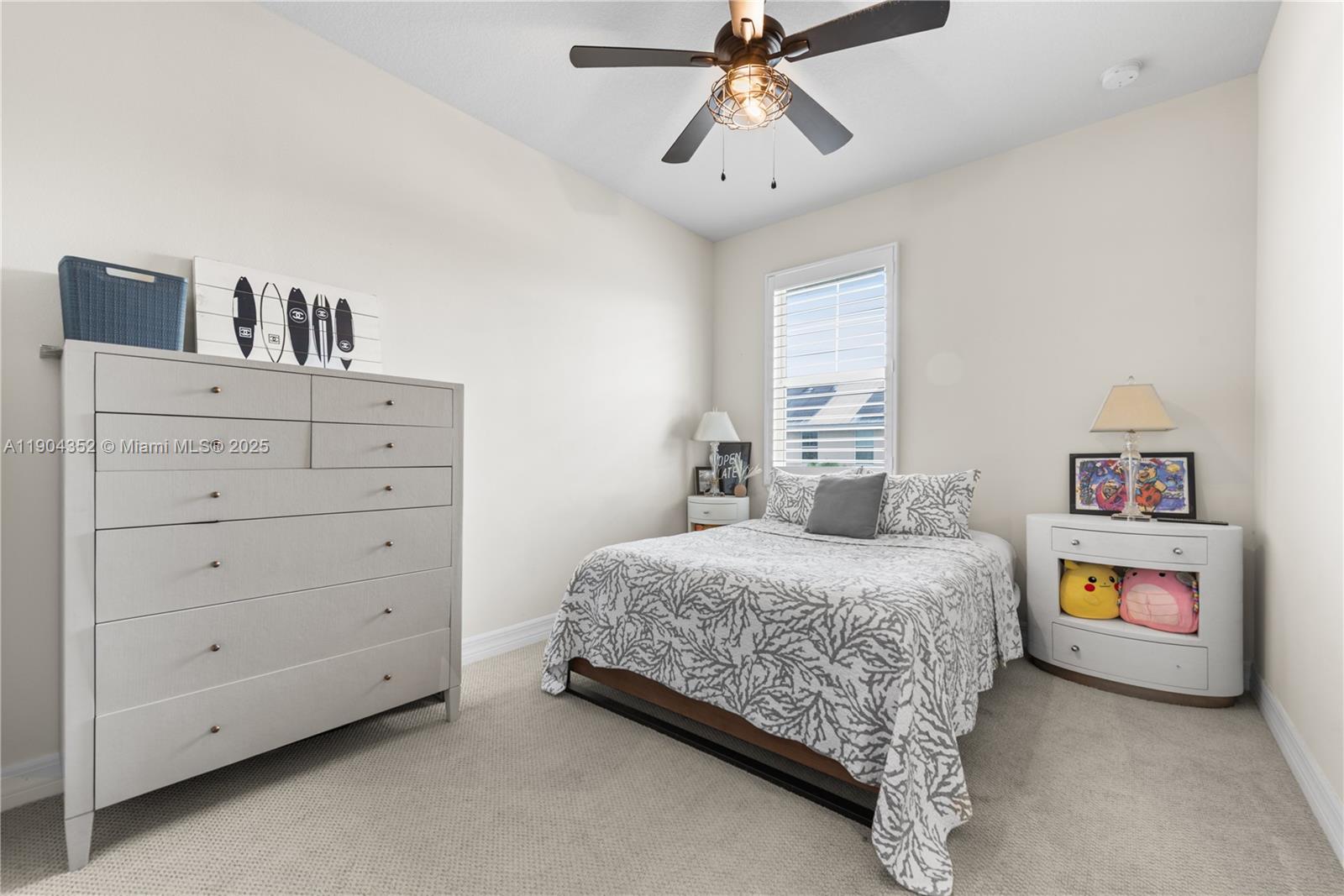 1030 Eucalyptus Drive, Unit 2 Hollywood, FL 33021 - Photo 15 of 22 a bedroom with a bed and a chandelier