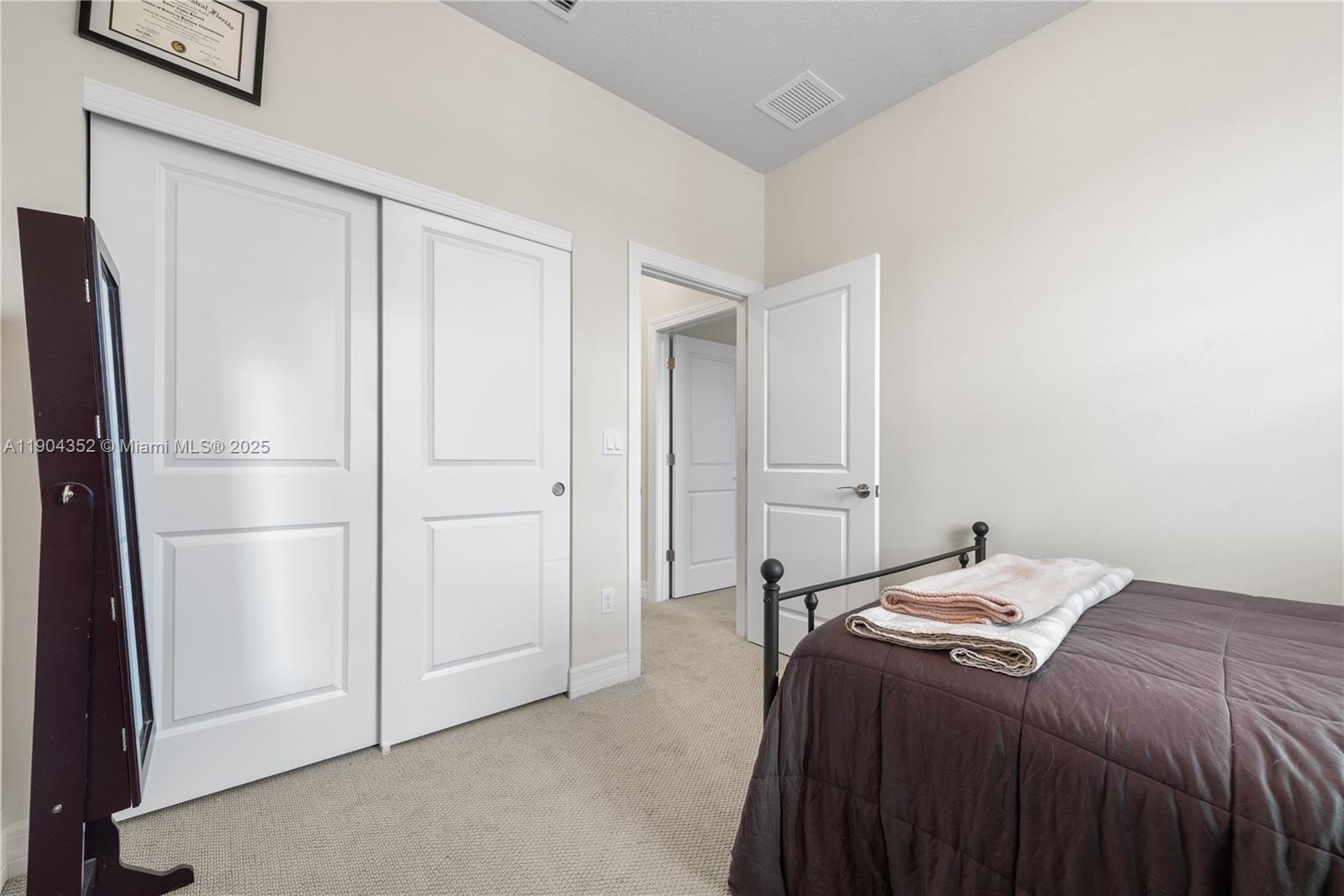 1030 Eucalyptus Drive, Unit 2 Hollywood, FL 33021 - Photo 19 of 22 a bedroom with a bed and a refrigerator