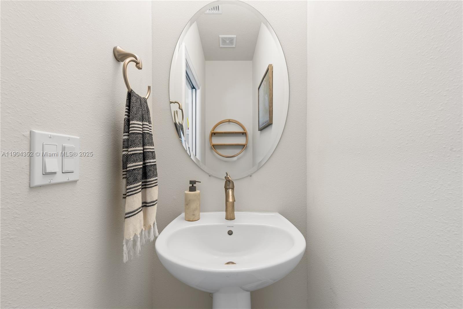 1030 Eucalyptus Drive, Unit 2 Hollywood, FL 33021 - Photo 20 of 22 a bathroom with a sink and a mirror