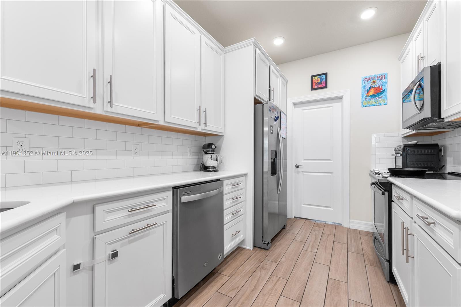 1030 Eucalyptus Drive, Unit 2 Hollywood, FL 33021 - Photo 9 of 22 a kitchen with cabinets and stainless steel appliances
