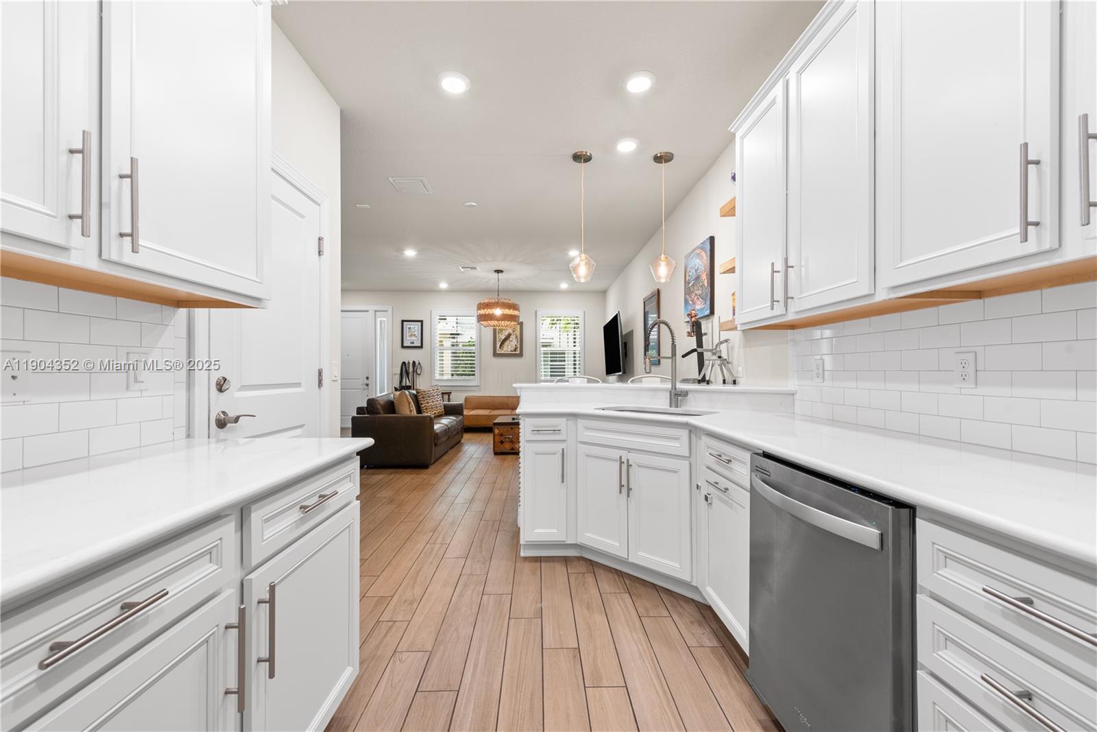 1030 Eucalyptus Drive, Unit 2 Hollywood, FL 33021 - Photo 10 of 22 a kitchen with lot of cabinets and wooden floor