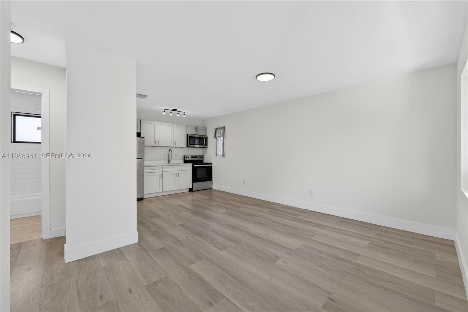 37 Northwest 59th Street, Unit 7 Miami, FL 33127 - Photo 11 of 19 a view of empty room with wooden floor
