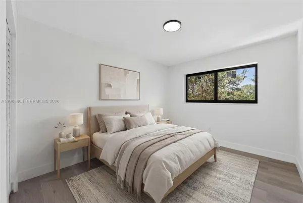 a bedroom with a bed and a wall painting