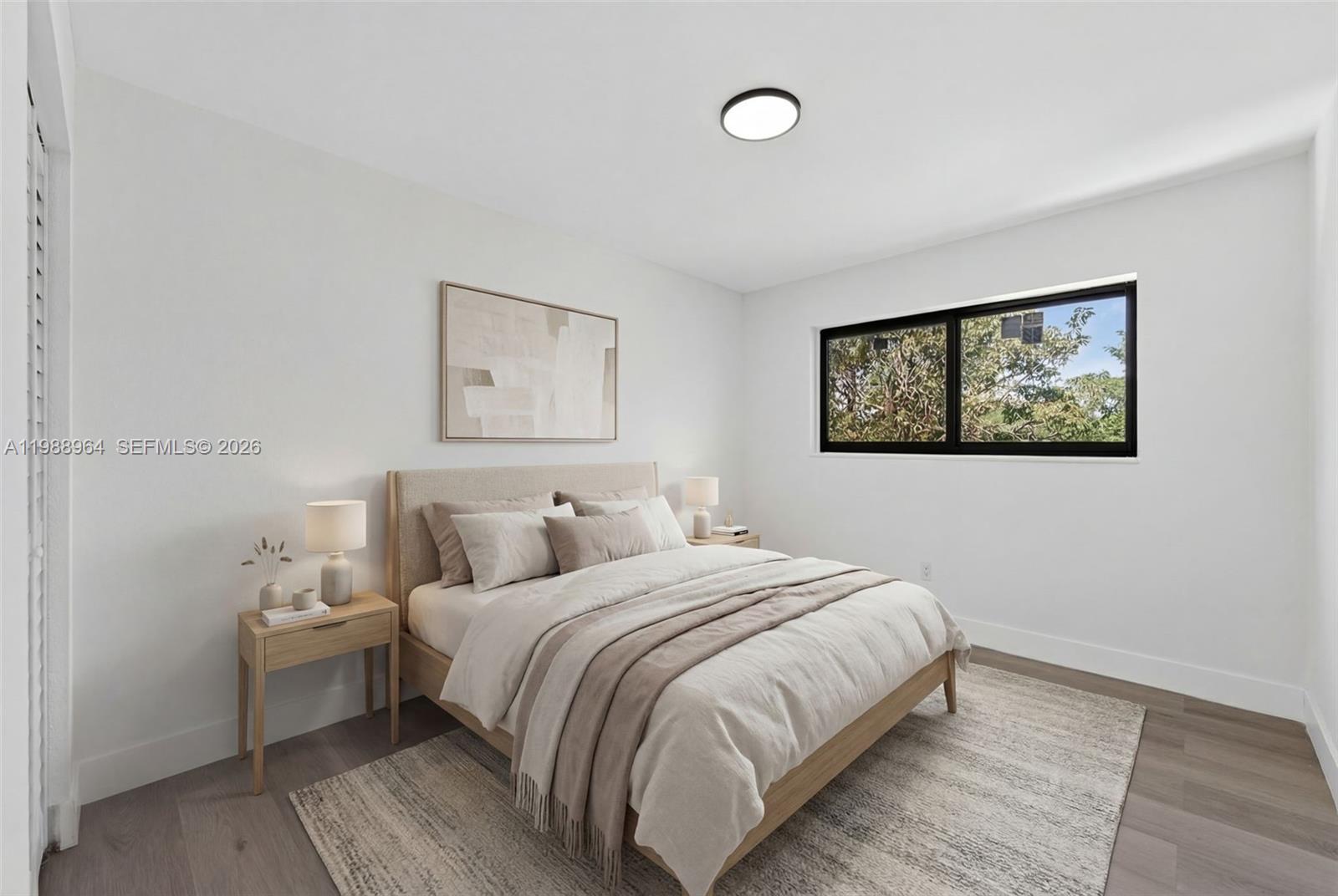 37 Northwest 59th Street, Unit 7 Miami, FL 33127 - Photo 14 of 19 a bedroom with a bed and a wall painting