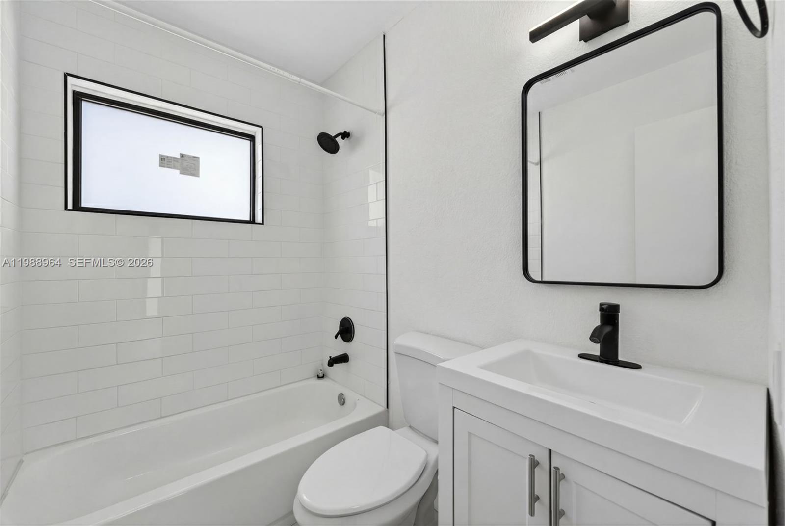 37 Northwest 59th Street, Unit 7 Miami, FL 33127 - Photo 15 of 19 a bathroom with a toilet sink and a bathtub