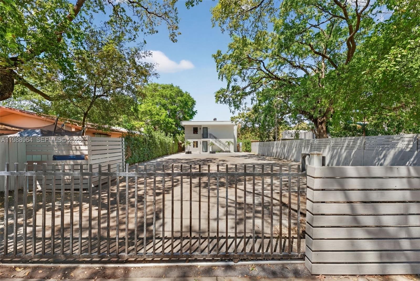 37 Northwest 59th Street, Unit 7 Miami, FL 33127 - Photo 3 of 19 a front view of a house with a garden