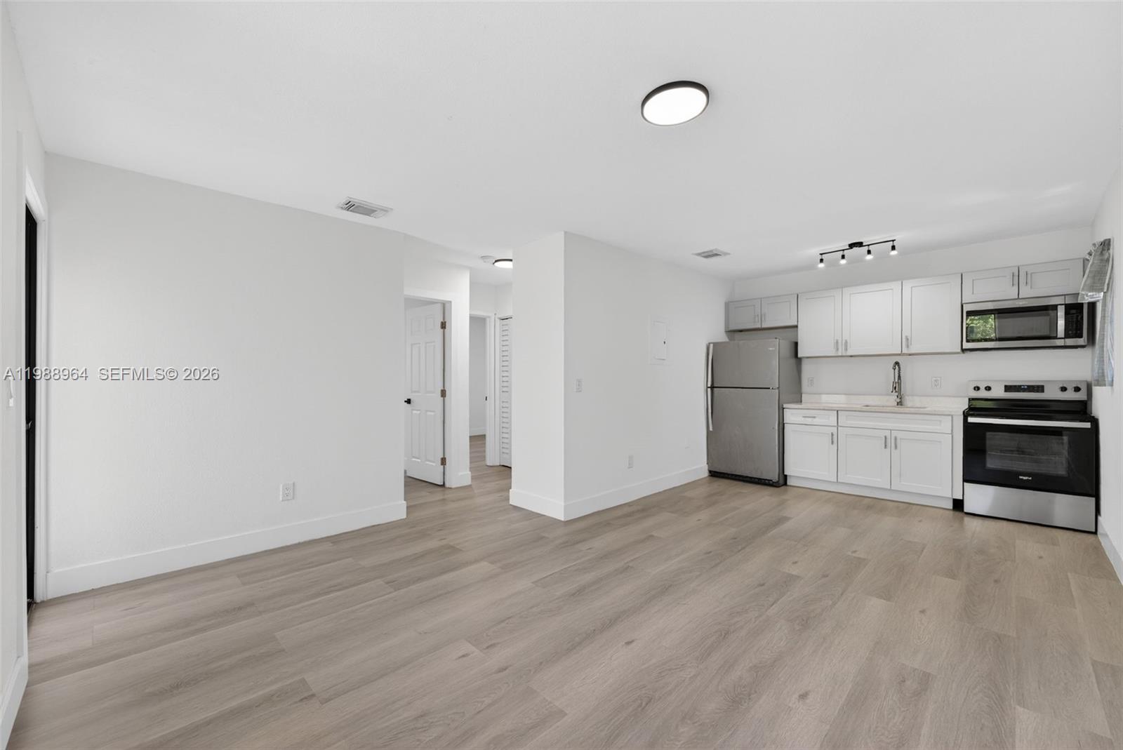 37 Northwest 59th Street, Unit 7 Miami, FL 33127 - Photo 10 of 19 a view of kitchen with stainless steel appliances a refrigerator and a stove top oven