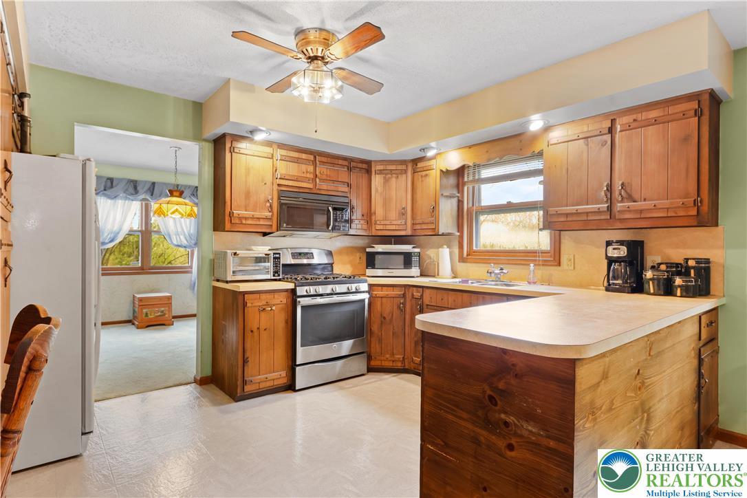 228 Cherry Hill Road Nazareth, PA 18064 - Photo 12 of 51 a kitchen with stainless steel appliances granite countertop a stove refrigerator sink and dishwasher