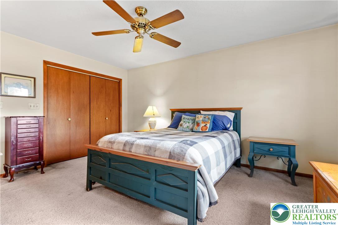 228 Cherry Hill Road Nazareth, PA 18064 - Photo 27 of 51 a bedroom with a bed and a chandelier