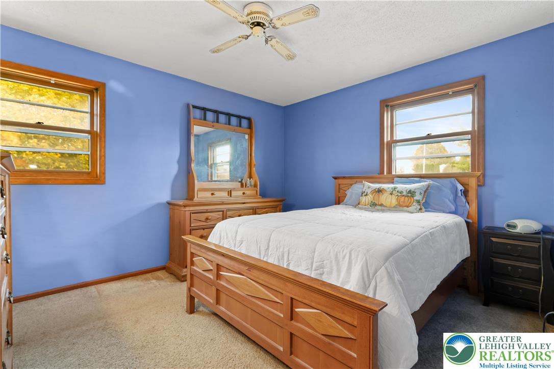 228 Cherry Hill Road Nazareth, PA 18064 - Photo 28 of 51 a bed sitting in a bedroom next to a window