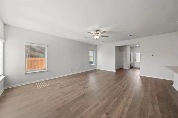 a kitchen with stainless steel appliances granite countertop a sink a microwave a refrigerator and a stove