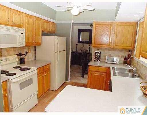 104 Hickory Road Somerset, NJ 08873 - Photo 4 of 10 a kitchen with stainless steel appliances granite countertop a refrigerator a stove a sink and a microwave