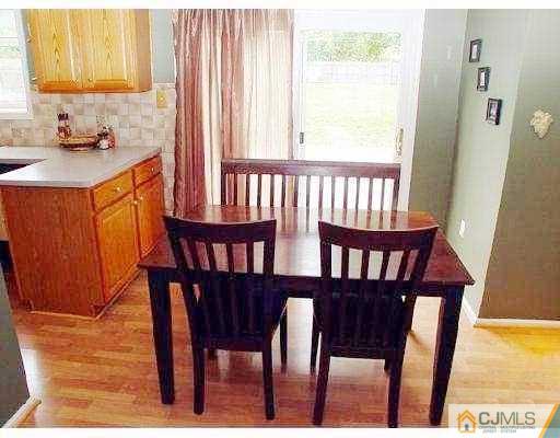 104 Hickory Road Somerset, NJ 08873 - Photo 5 of 10 a view of a dining room with furniture window and wooden floor
