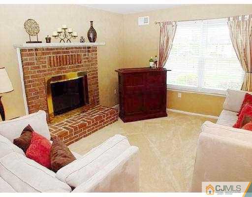 104 Hickory Road Somerset, NJ 08873 - Photo 6 of 10 a living room with furniture and a fireplace