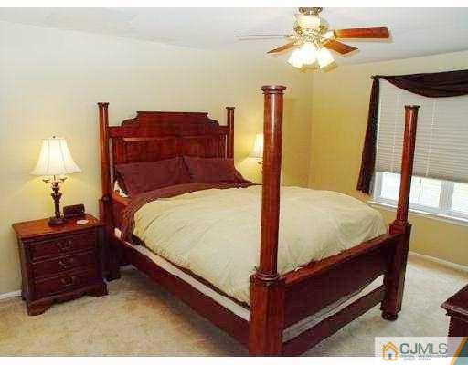 104 Hickory Road Somerset, NJ 08873 - Photo 7 of 10 a bed sitting in a bedroom next to a window