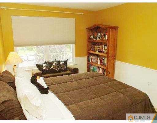 104 Hickory Road Somerset, NJ 08873 - Photo 10 of 10 a bed sitting in a bedroom next to a window