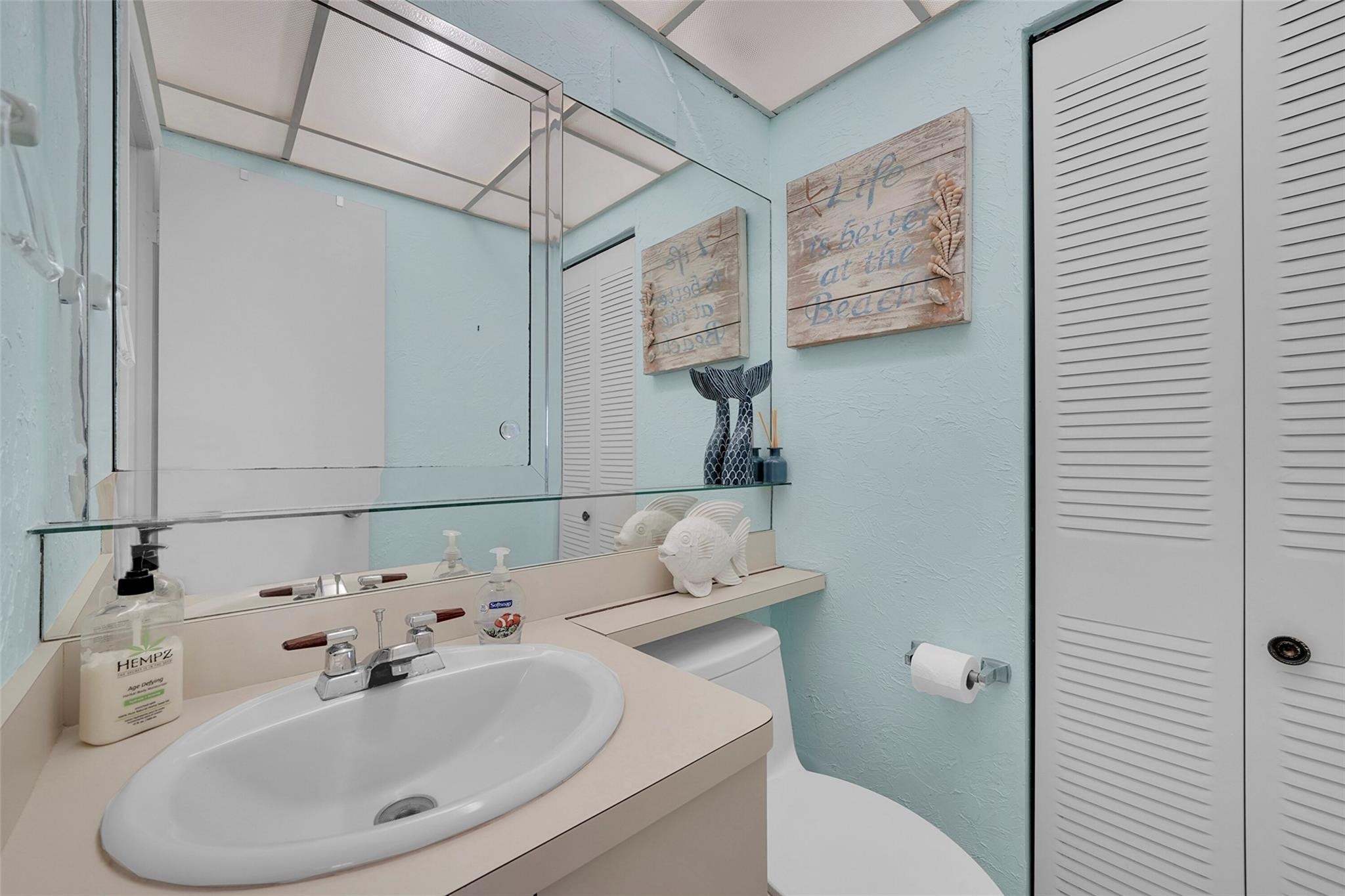 400 North Surf Road, Unit 503 Hollywood, FL 33019 - Photo 11 of 35 a bathroom with a sink and mirror with toilet