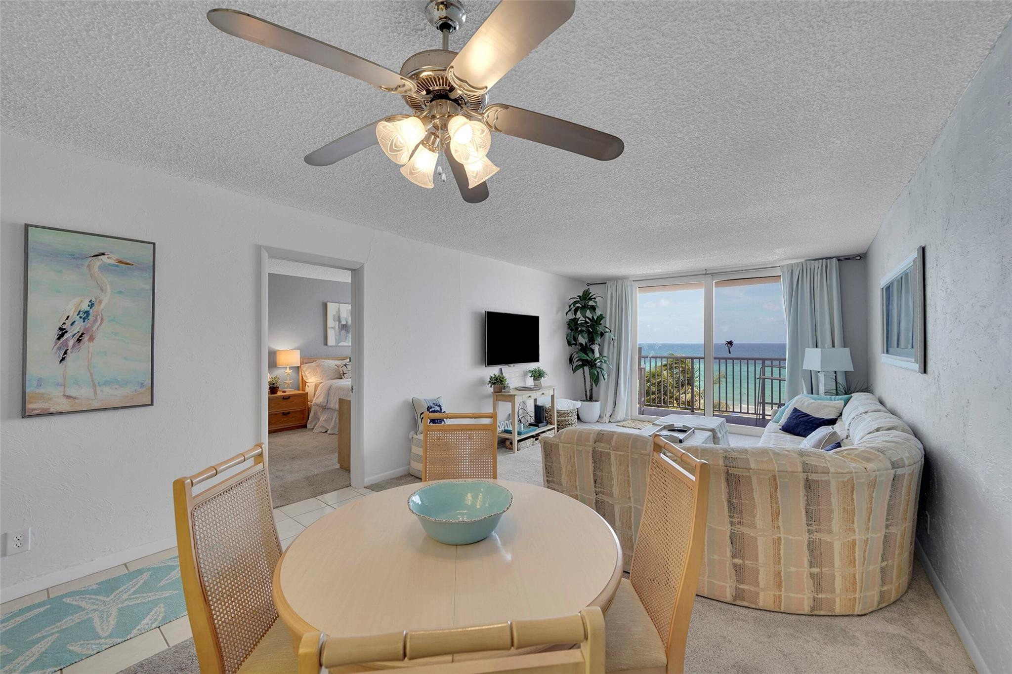 400 North Surf Road, Unit 503 Hollywood, FL 33019 - Photo 13 of 35 a dining room with furniture a chandelier and a flat screen tv