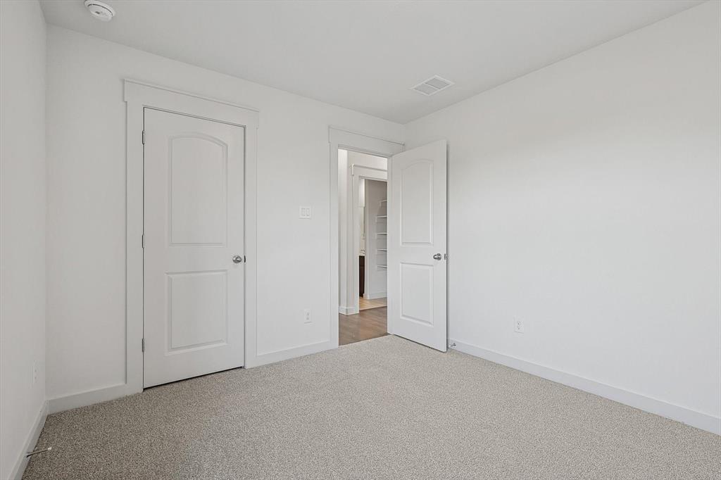 1714 Glacial Beech Place Forney, TX 75126 - Photo 19 of 25 Unfurnished bedroom featuring carpet and baseboards