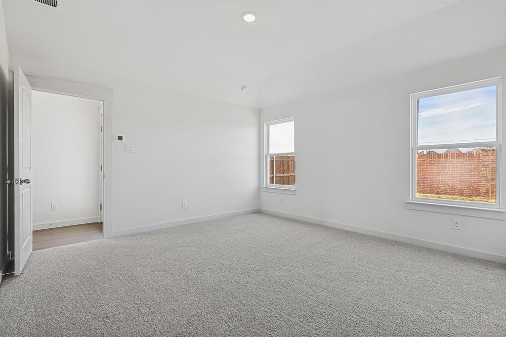 1714 Glacial Beech Place Forney, TX 75126 - Photo 20 of 25 Empty room with light carpet and recessed lighting