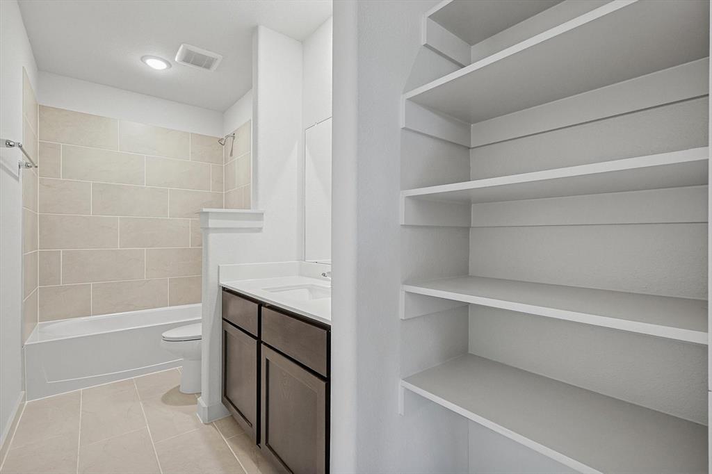 1714 Glacial Beech Place Forney, TX 75126 - Photo 22 of 25 Full bathroom featuring vanity, shower / tub combination, light tile patterned flooring, and a closet