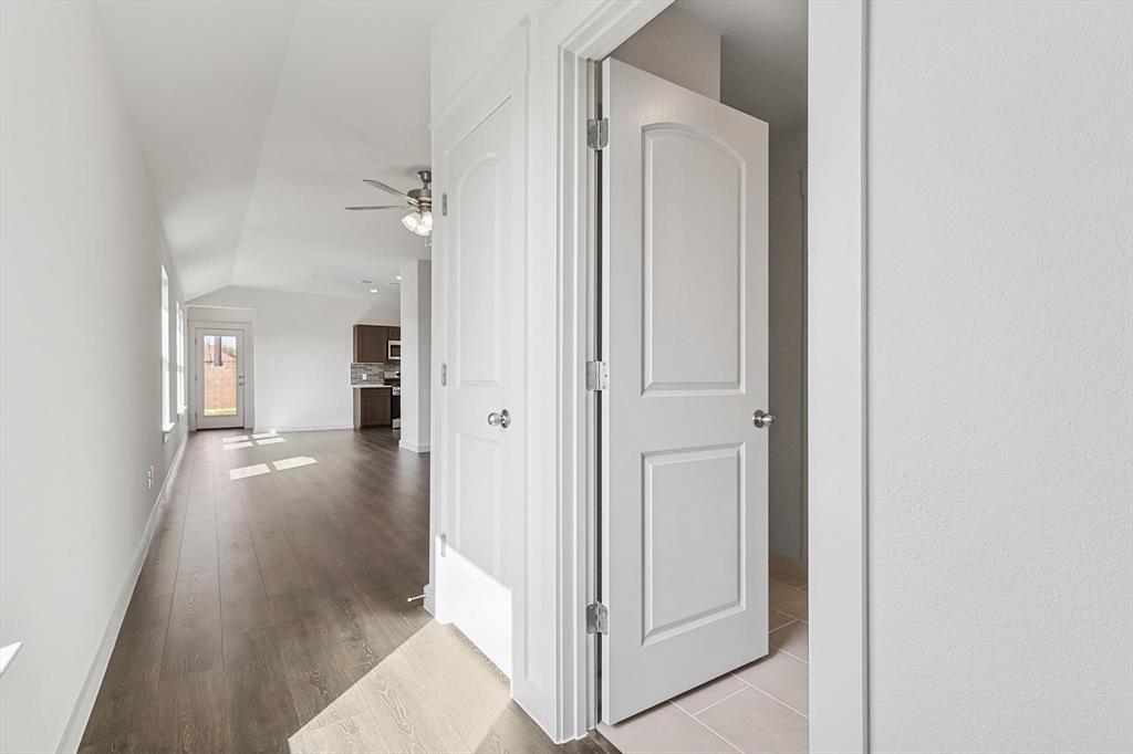 1714 Glacial Beech Place Forney, TX 75126 - Photo 3 of 25 Hall with lofted ceiling and light wood-type flooring