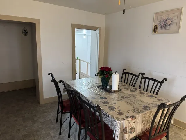 a view of a workspace with furniture and a refrigerator