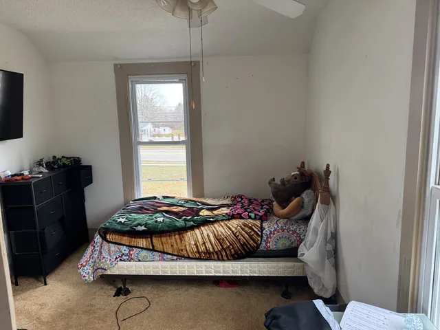 a bedroom with a bed and walk in closet