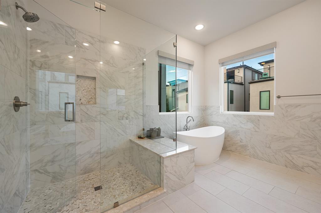 4113 Entrada Way Dallas, TX 75219 - Photo 18 of 32 Spa inspired primary bath with standalone tub and large walk-in shower.
