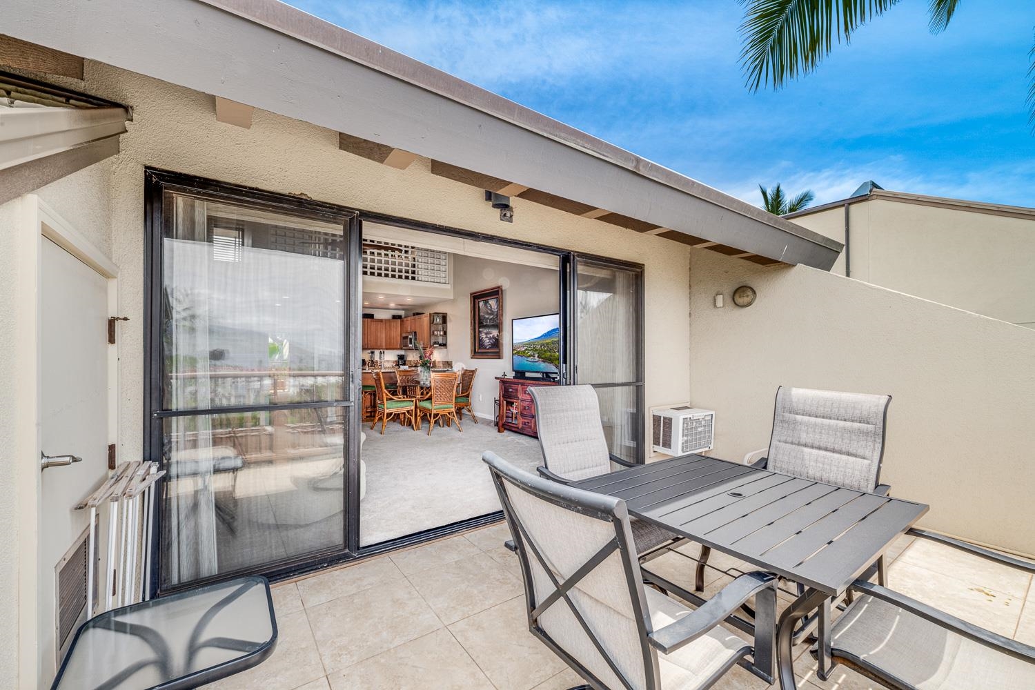 2777 South Kihei Road, Unit J214 Kihei, HI 96753 - Photo 11 of 46 a dining room with furniture and a floor to ceiling window