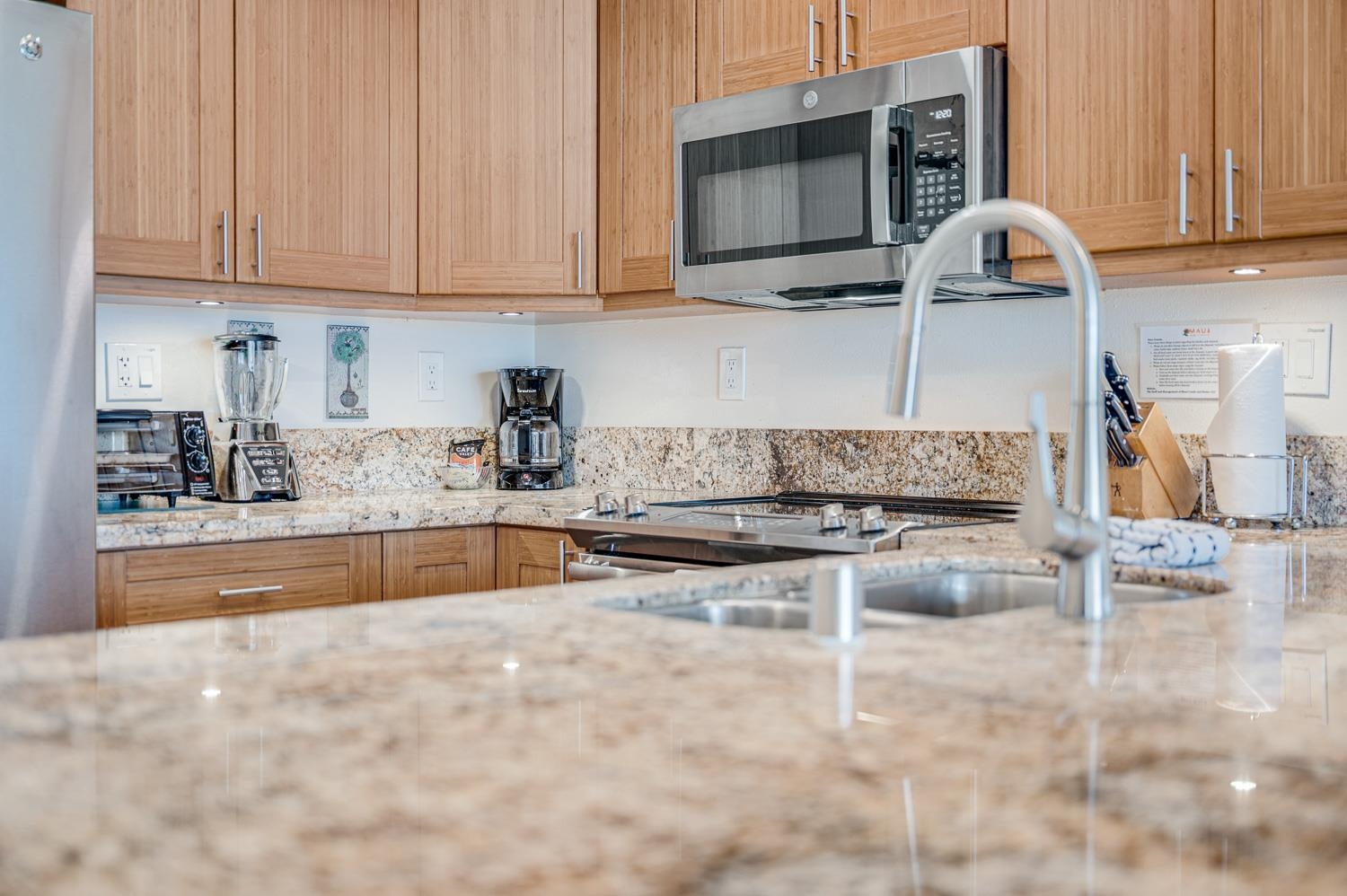 2777 South Kihei Road, Unit J214 Kihei, HI 96753 - Photo 15 of 46 a kitchen with stainless steel appliances granite countertop a stove and a white cabinets