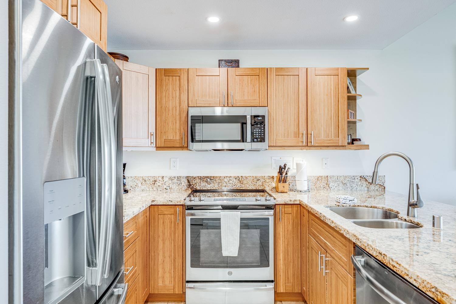 2777 South Kihei Road, Unit J214 Kihei, HI 96753 - Photo 17 of 46 a kitchen with stainless steel appliances granite countertop a stove a sink and a microwave