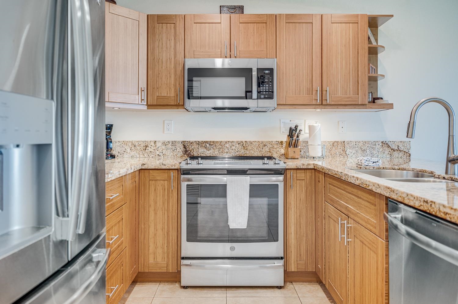 2777 South Kihei Road, Unit J214 Kihei, HI 96753 - Photo 18 of 46 a kitchen with stainless steel appliances granite countertop a stove microwave and sink