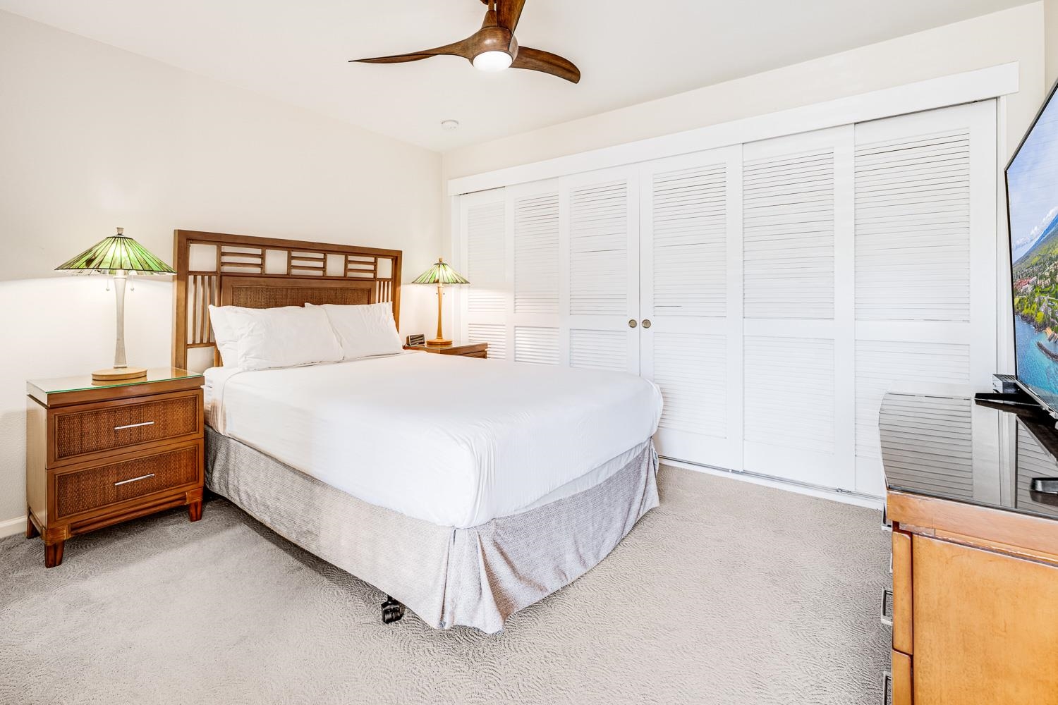 2777 South Kihei Road, Unit J214 Kihei, HI 96753 - Photo 30 of 46 a bedroom with a bed and a walk in closet