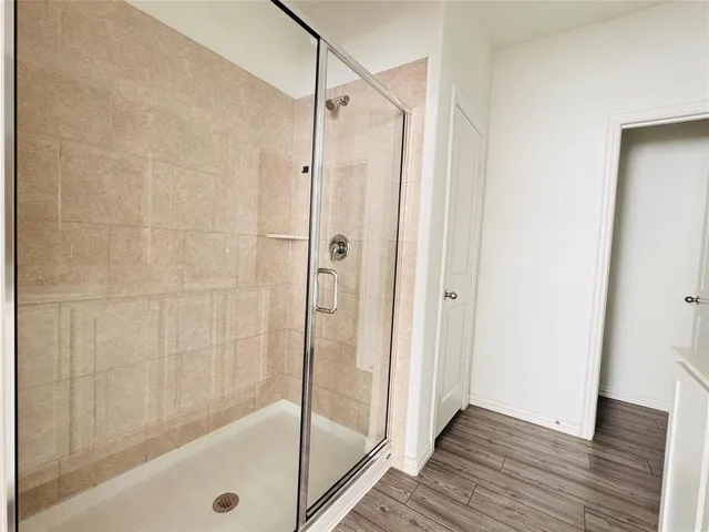a bathroom with a glass shower door