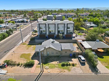 an aerial view of a house with a yard