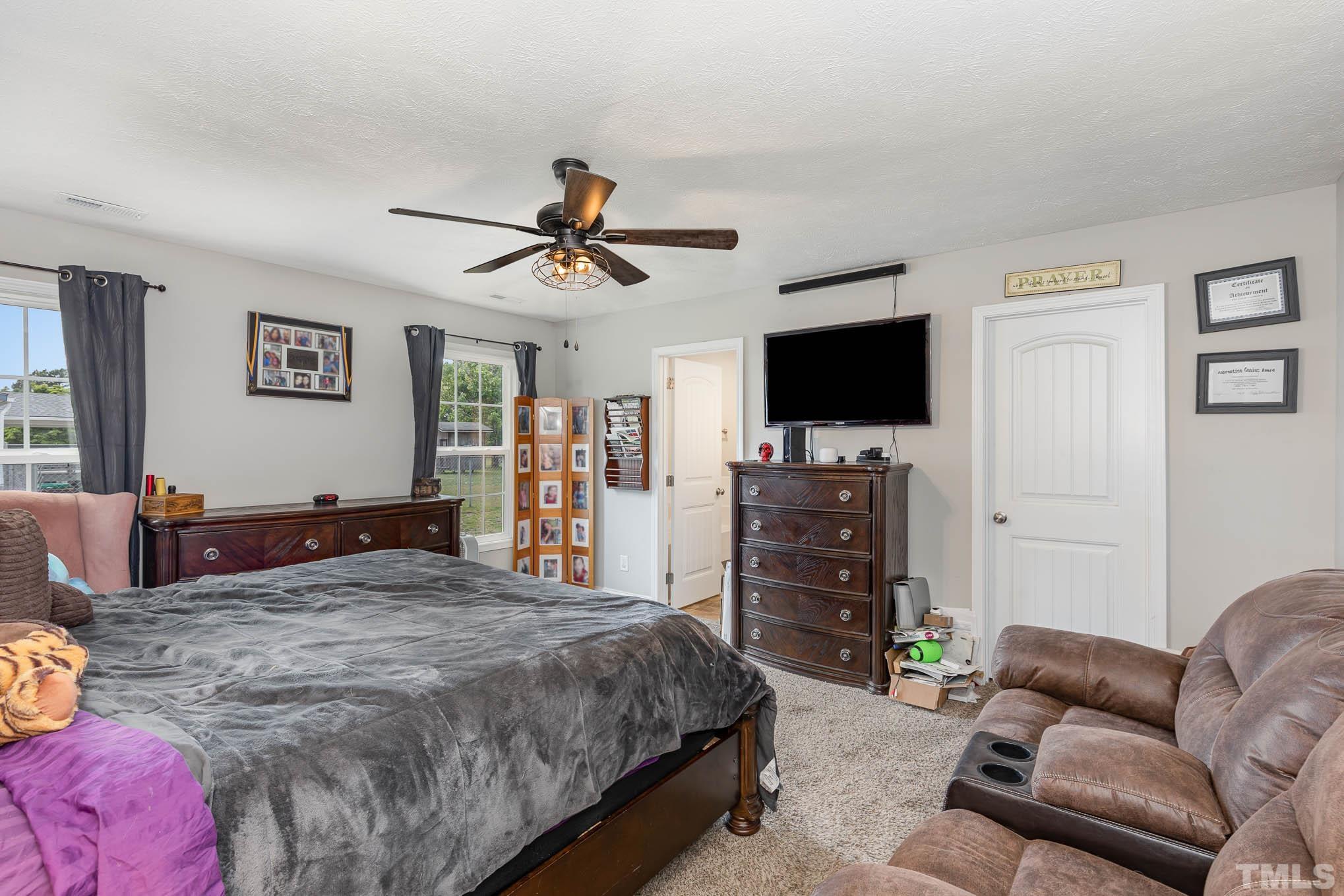 6551 Faircloth Bridge Road Stedman, NC 28391 - Photo 15 of 30 a living room with furniture and a flat screen tv