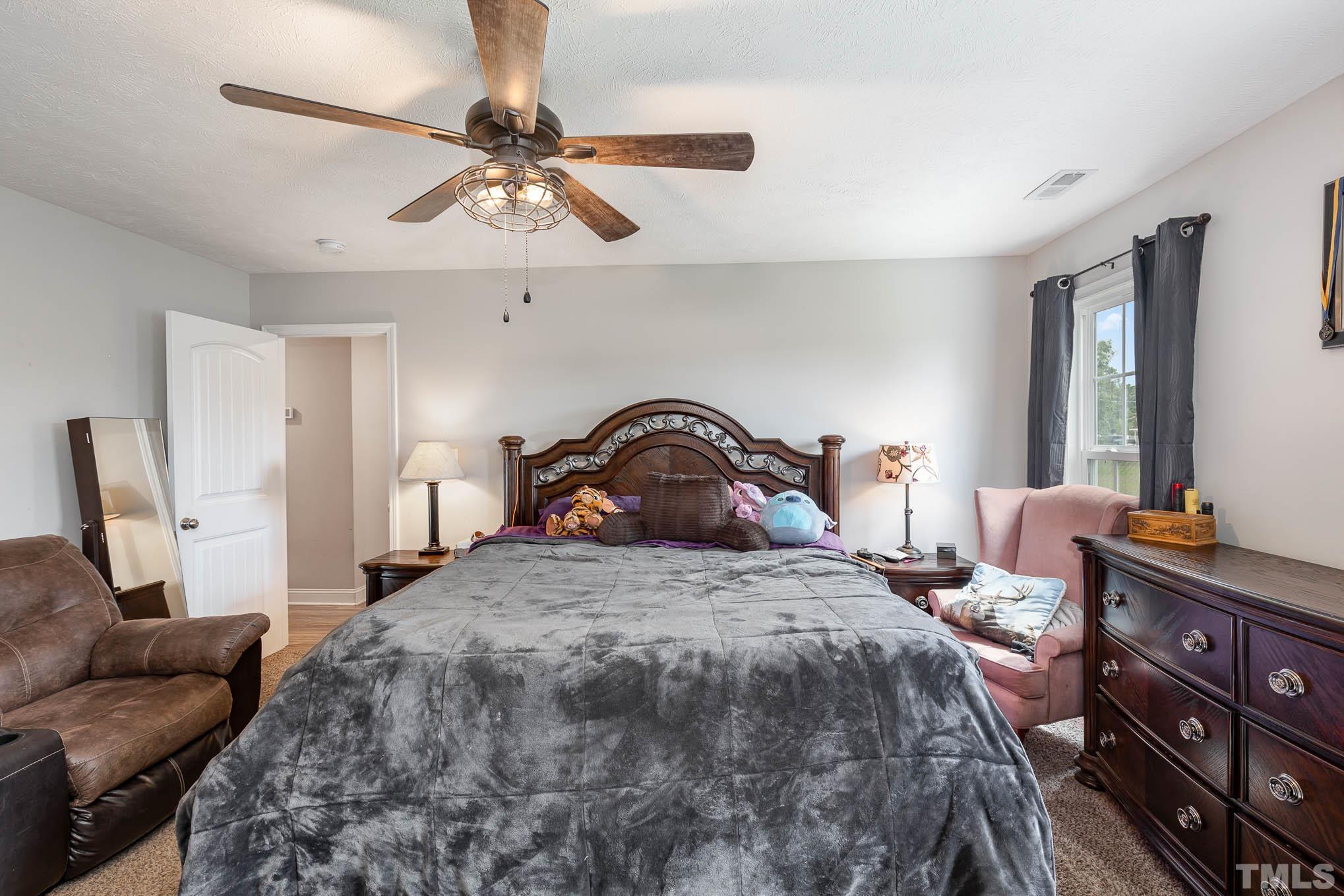 6551 Faircloth Bridge Road Stedman, NC 28391 - Photo 16 of 30 a bedroom with a bed and a couch