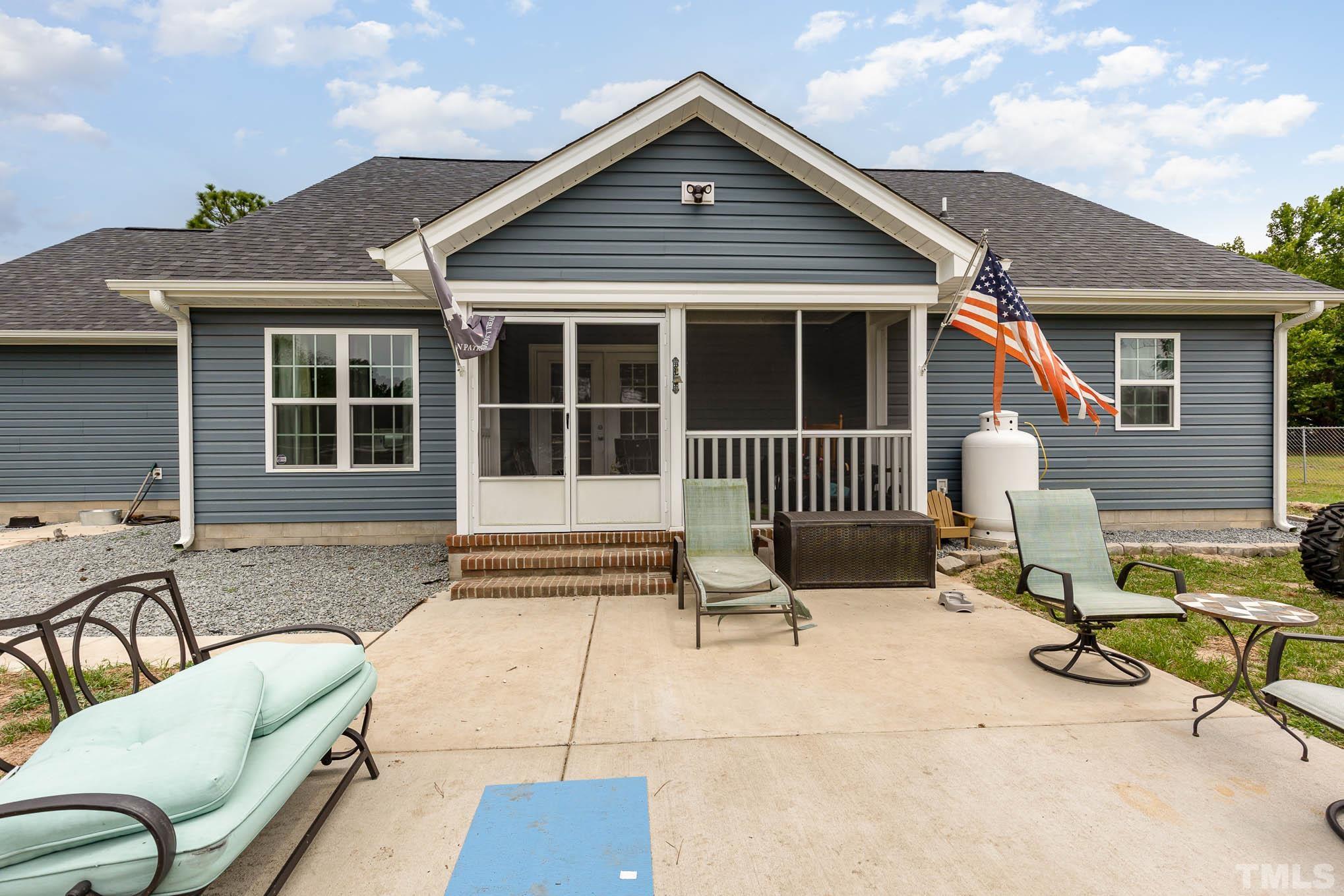 6551 Faircloth Bridge Road Stedman, NC 28391 - Photo 23 of 30 a view of a house with a patio and a yard